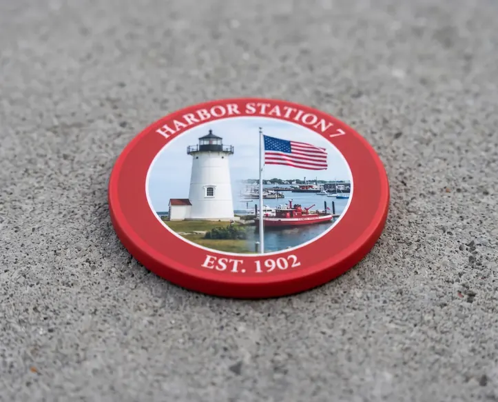 A flat matte ceramic coin with a red border and a matching red edge